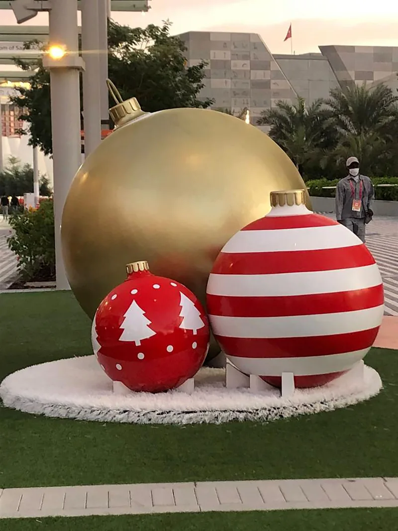Evolution Scenic repaired oversized red and gold baubles with seasonal painted graphics