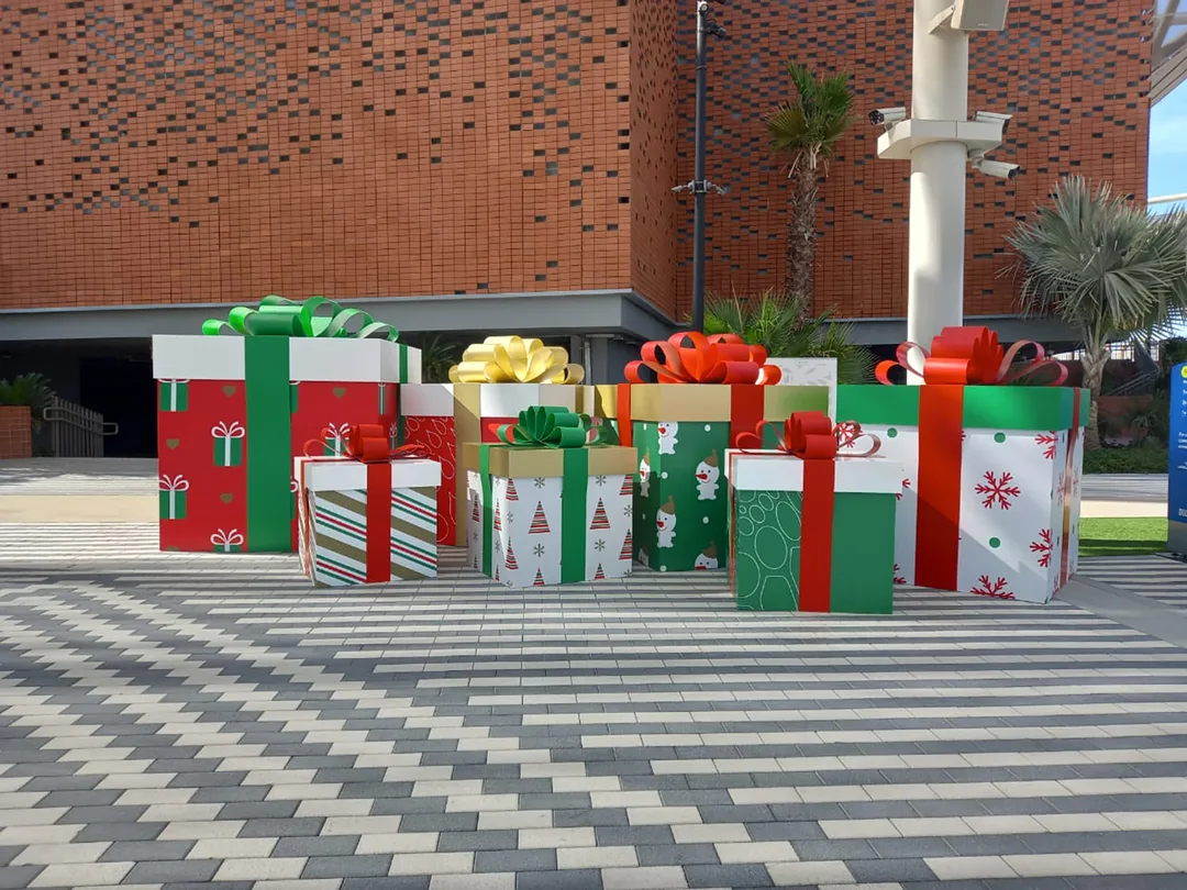 Large festive gift structures integrated into the temporary Christmas scenic environment in Dubai.