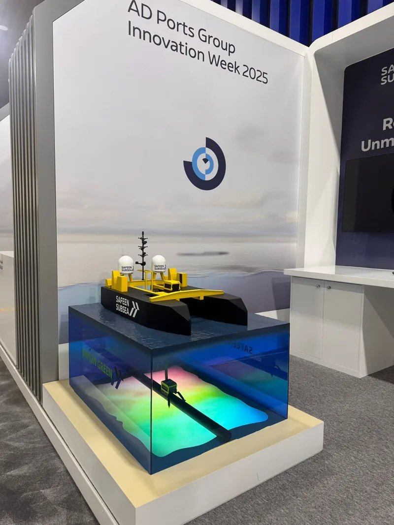 White scenic exhibition walling finished with project graphics and recessed screen positions.