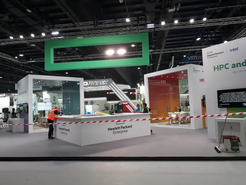 Custom MDF exhibition architecture and illuminated overhead feature fabricated by Evolution Scenic.