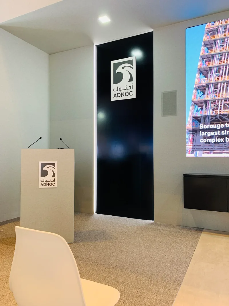 Painted MDF scenic structures forming the ADNOC presentation and exhibition environment at ADIPEC Abu Dhabi
