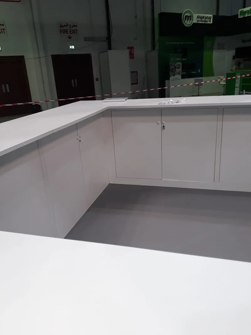 White painted scenic counter and branded wall structure within the HPE GITEX installation.