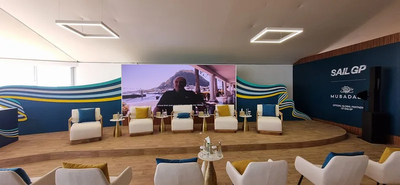 Custom curved scenic stage with vinyl flooring and branded display plinth.