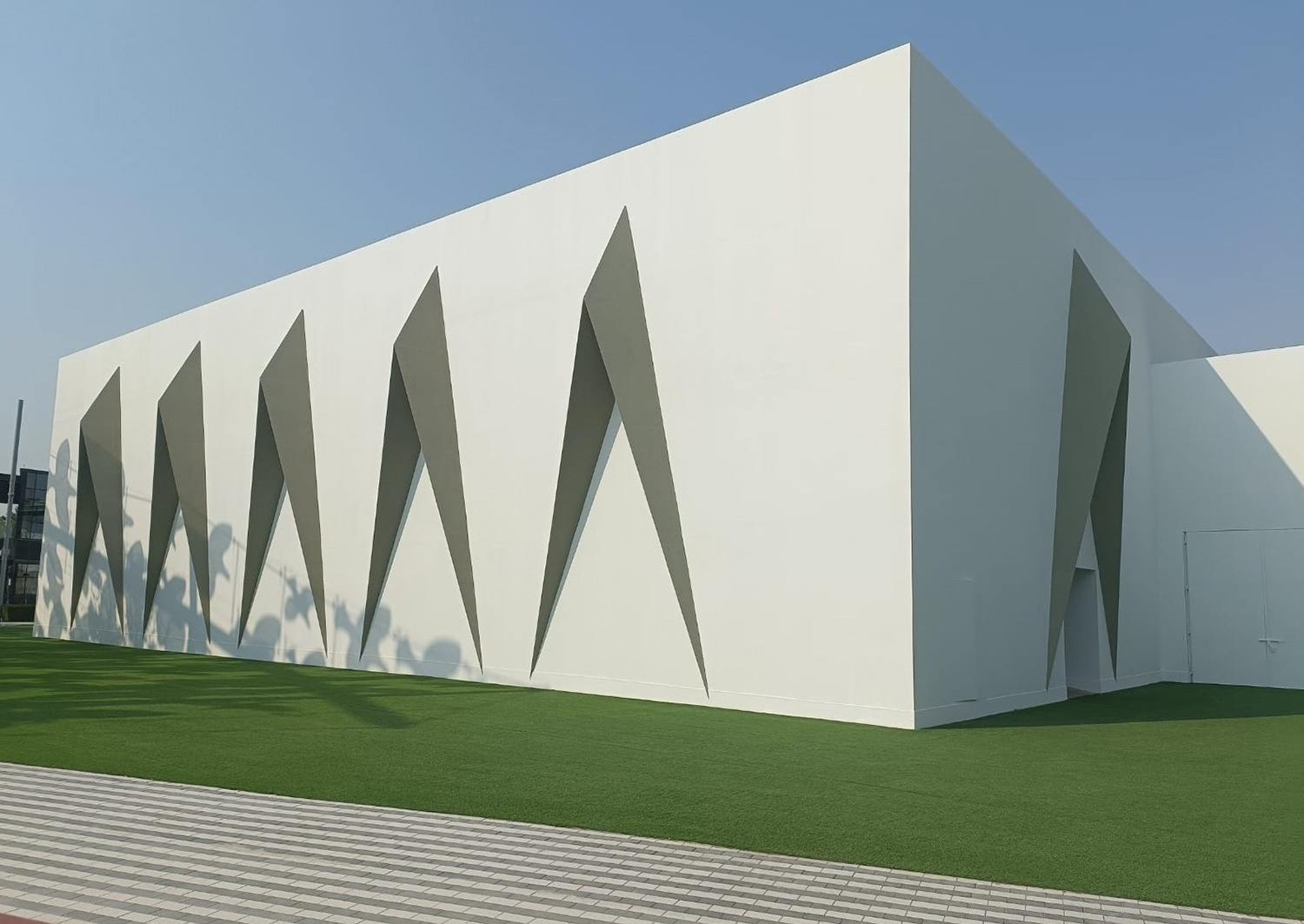 Steel-framed concrete-board walls enclosing the contractor-supplied temporary mosque structure.
