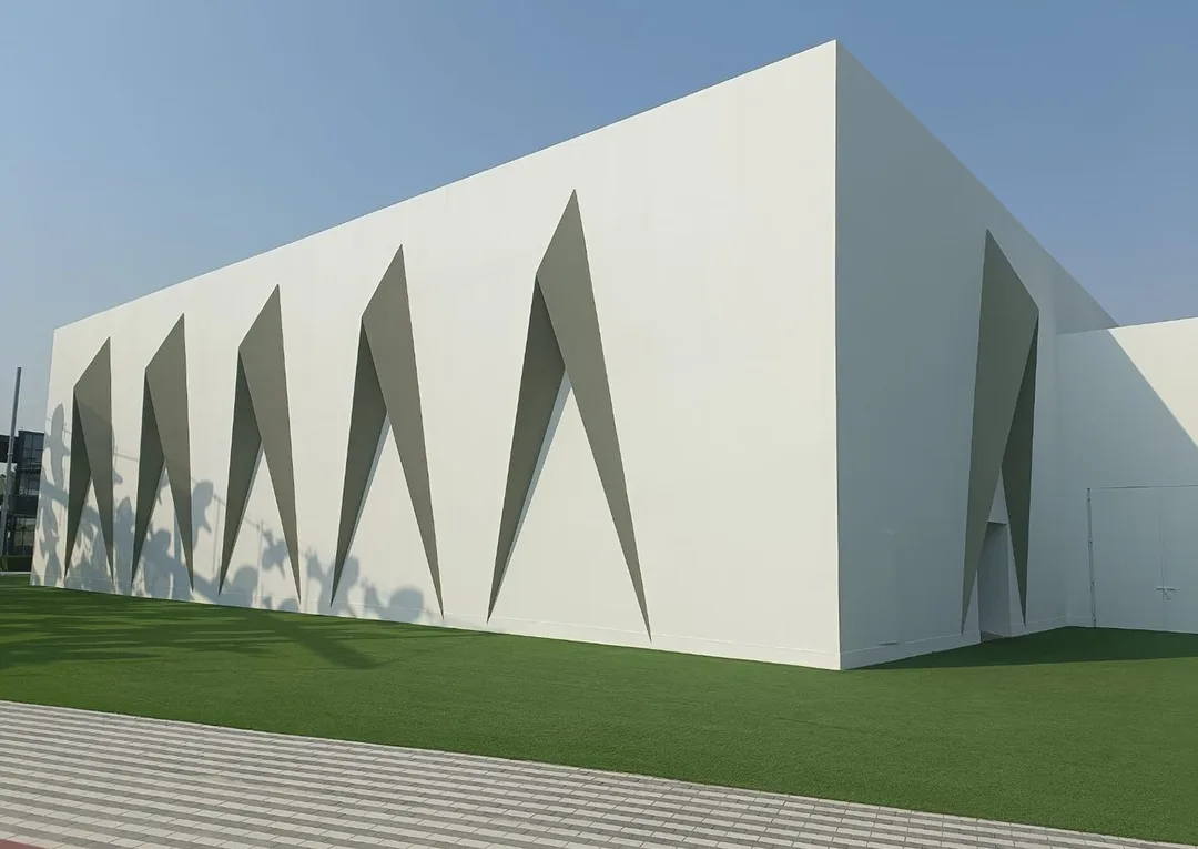 Steel-framed concrete-board walls enclosing the contractor-supplied temporary mosque structure.