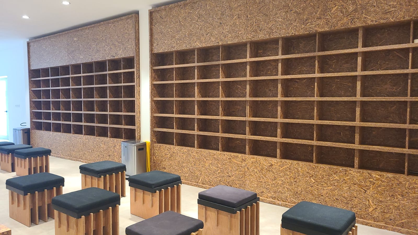 Custom shoe-storage joinery installed beside the temporary mosque prayer hall. 