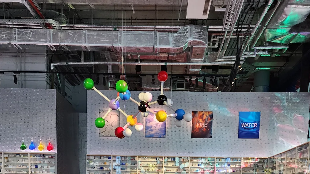 Evolution Scenic suspended Styrofoam molecule rigged above the Prada Mode Dubai interior.