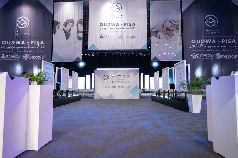 Branded MDF plinths and freestanding display panels within the Qudwa–PISA forum environment at Expo 2020 Dubai.