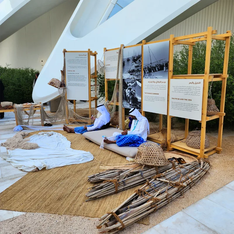 Recycled-material scenic components integrated into reusable UAE Pavilion display modules.