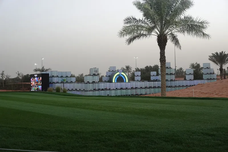 Sunset view of modular IBC scenic walls surrounding the interactive putting installation.