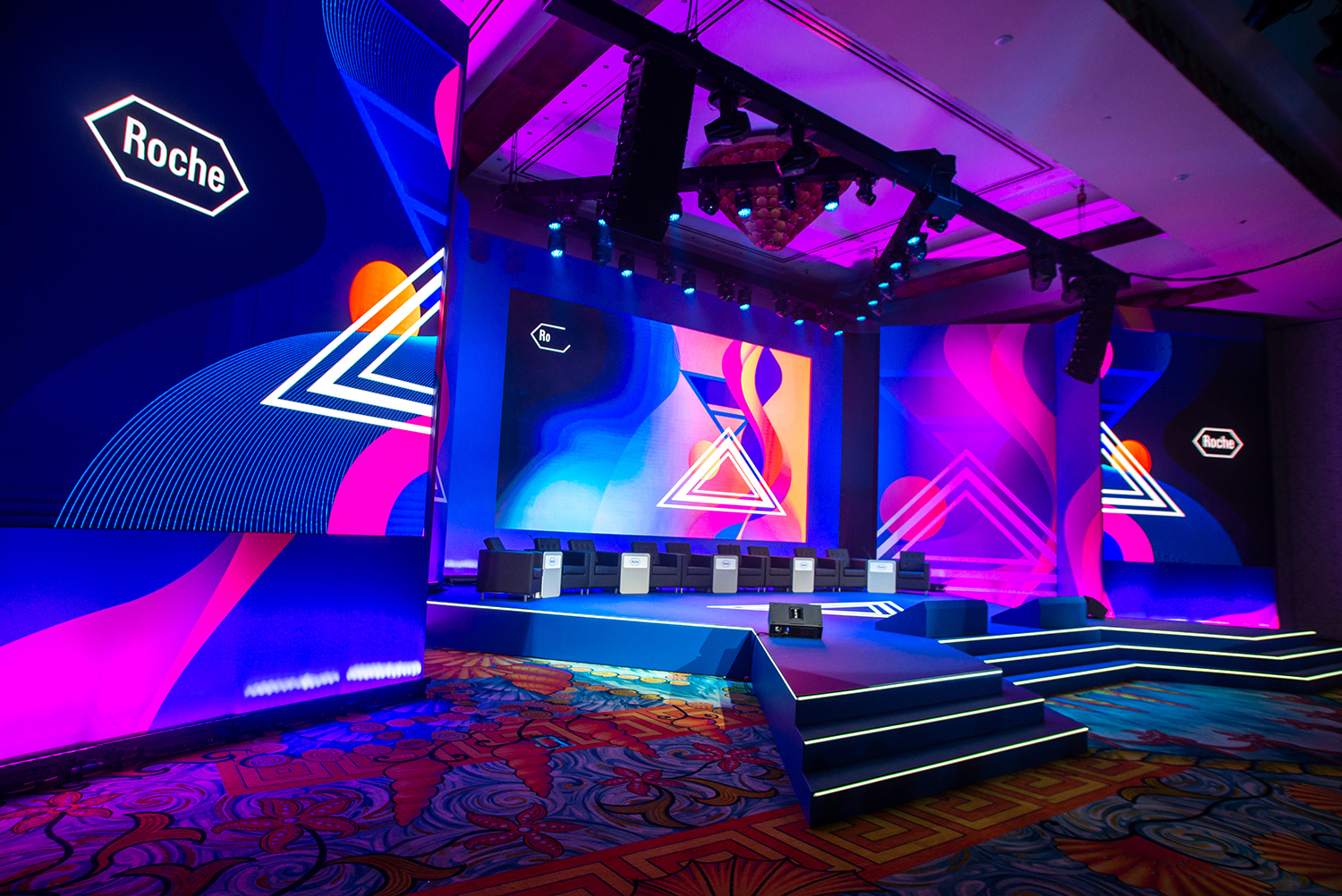 Evolution Scenic Roche conference stage with integrated LED screen surrounds in Dubai.