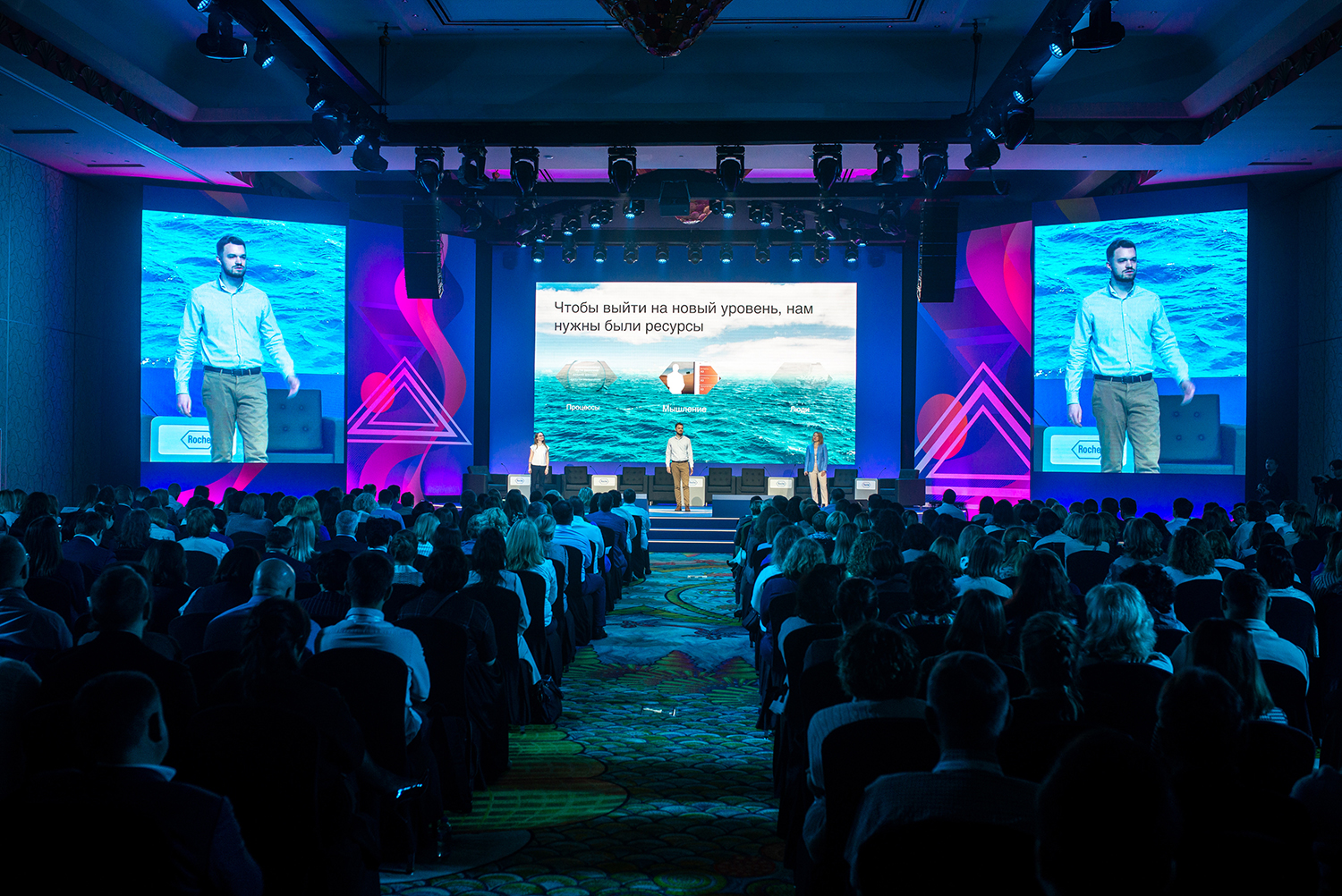 Integrated LED screens framed by custom Roche conference scenery in Dubai.