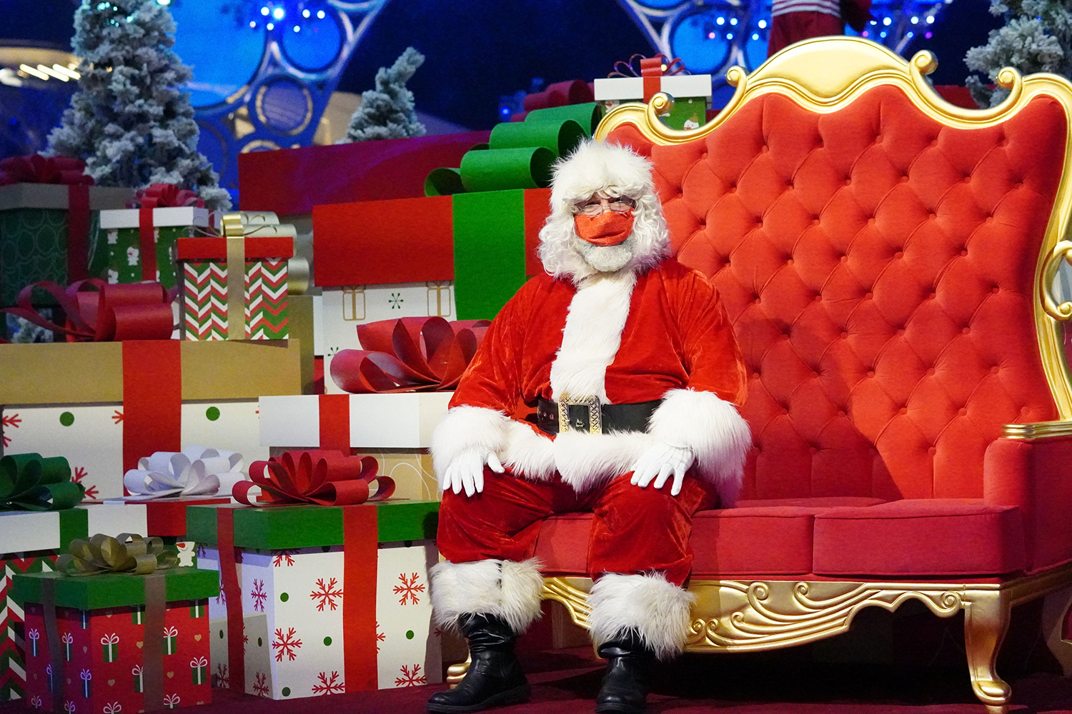 Custom Santa throne setting surrounded by oversized presents and snow-dressed festive scenery.