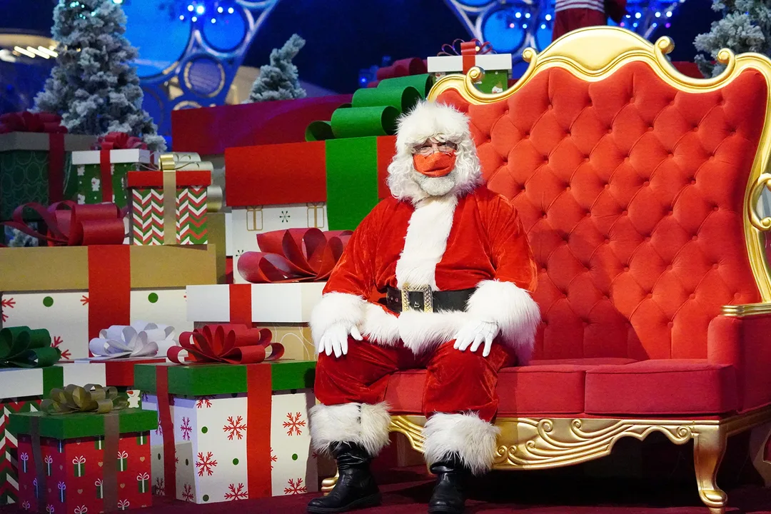 Custom Santa throne setting surrounded by oversized presents and snow-dressed festive scenery.