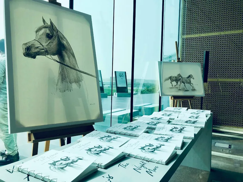 Book-display furniture integrated with the surrounding temporary scenic architecture.
