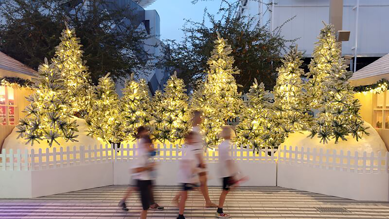 Tree-shaped scenic sculptures with artificial snow and coordinated Christmas decorative treatments.