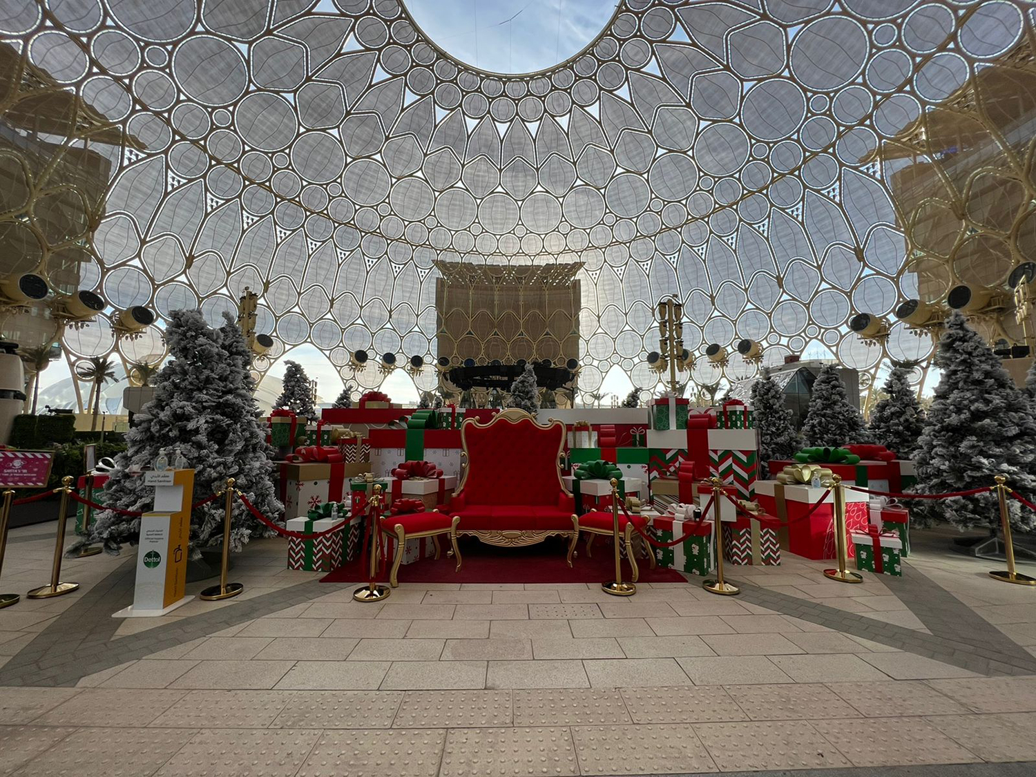 Snow-dressed scenic trees and gift-box structures installed throughout the Expo Christmas environment.