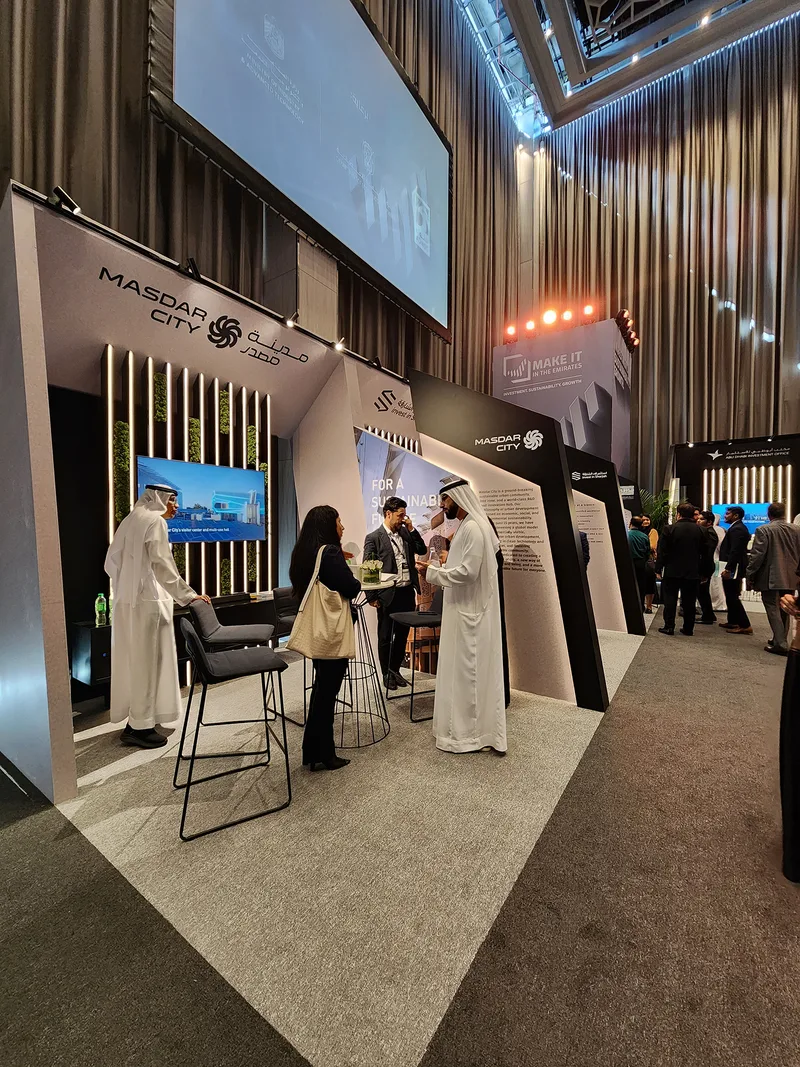 Evolution Scenic sponsor exhibition environment with angled walls and integrated display screens.