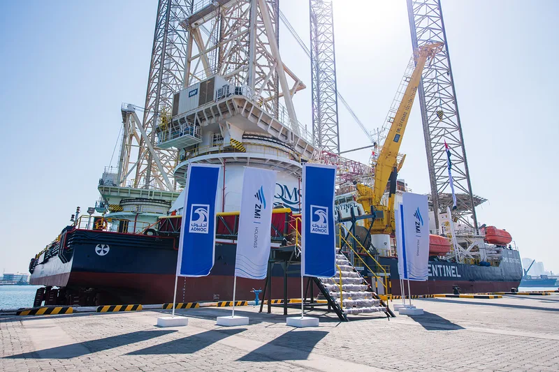 Custom advertising flags installed across the exterior barge access area.