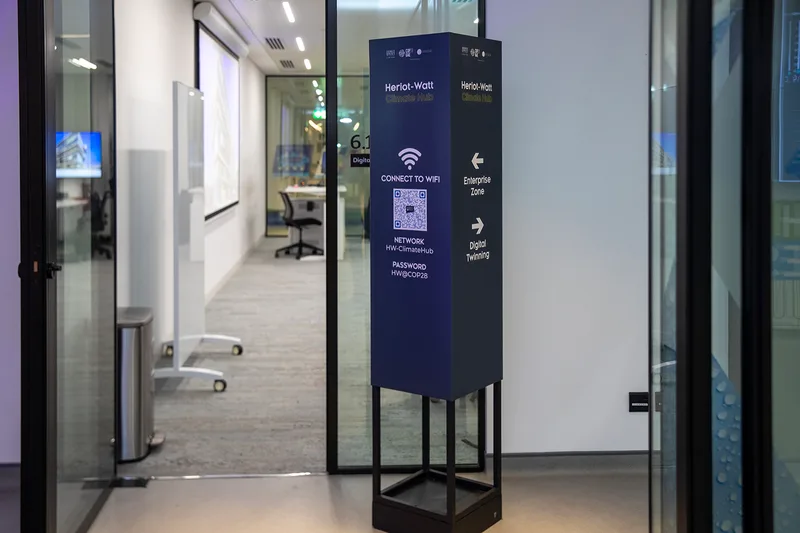 Steel-framed directional sign with MDF cladding and applied vinyl graphics.