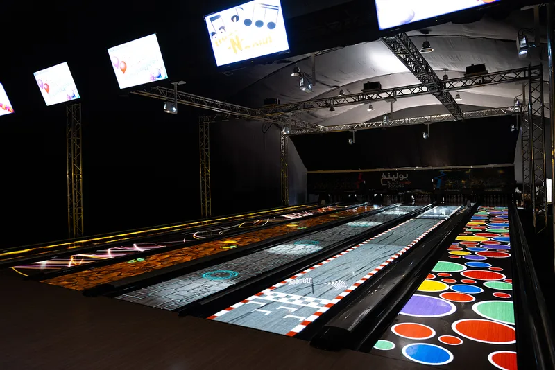 Black-and-white striped scenic flooring surrounding brightly coloured custom spherical props.