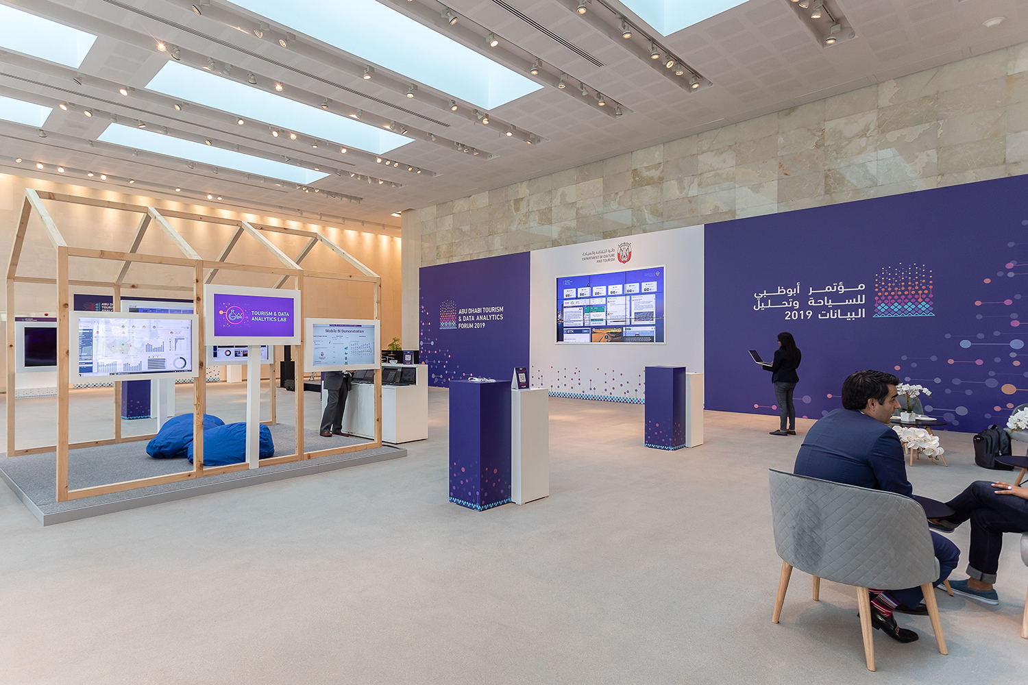 Tourism Data Lab displays combining timber structures, graphics and monitor kiosks.