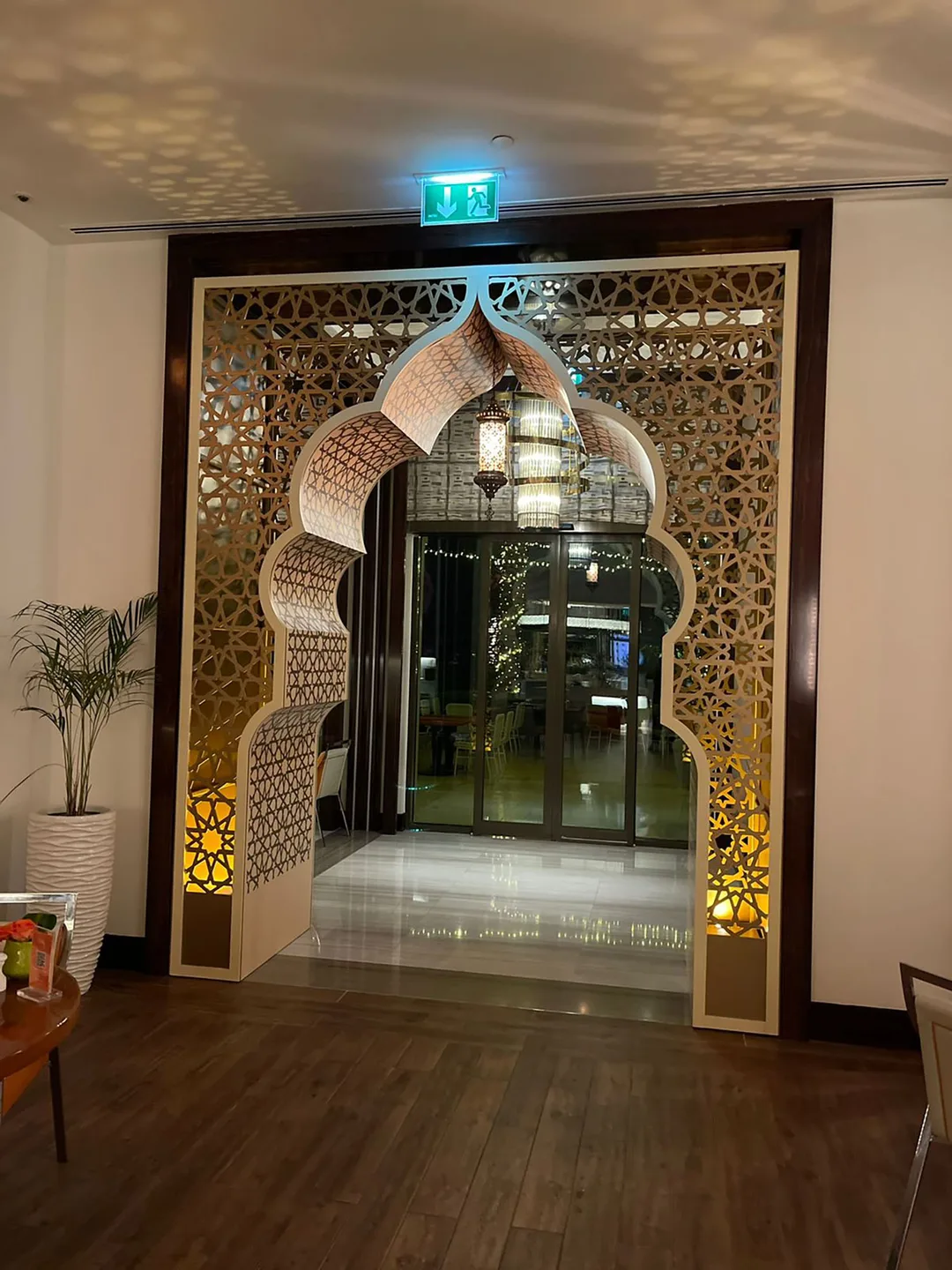 Decorative walkway portal repeating the mashrabiya language throughout the hospitality interior.