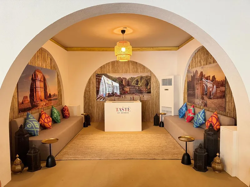 Textured painted wall panels paired with barasti finishes and acrylic branding.