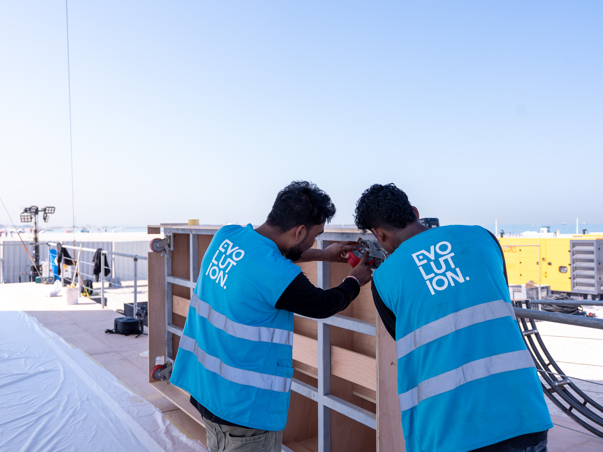 Evolution Scenic team fitting new timber cladding and branded panels onto an existing aluminium modular framework.
