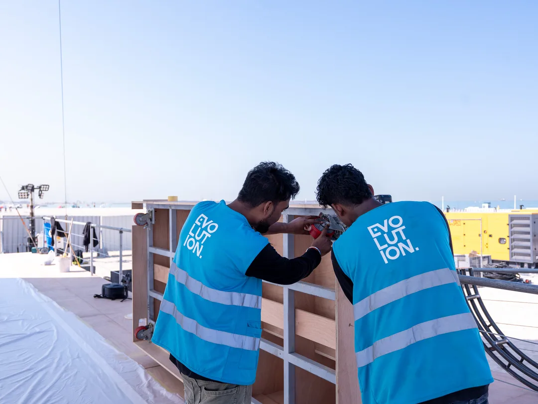 Evolution Scenic team fitting new timber cladding and branded panels onto an existing aluminium modular framework.
