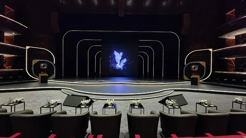 Curved stage extension built from steel decks with layered plywood and MDF