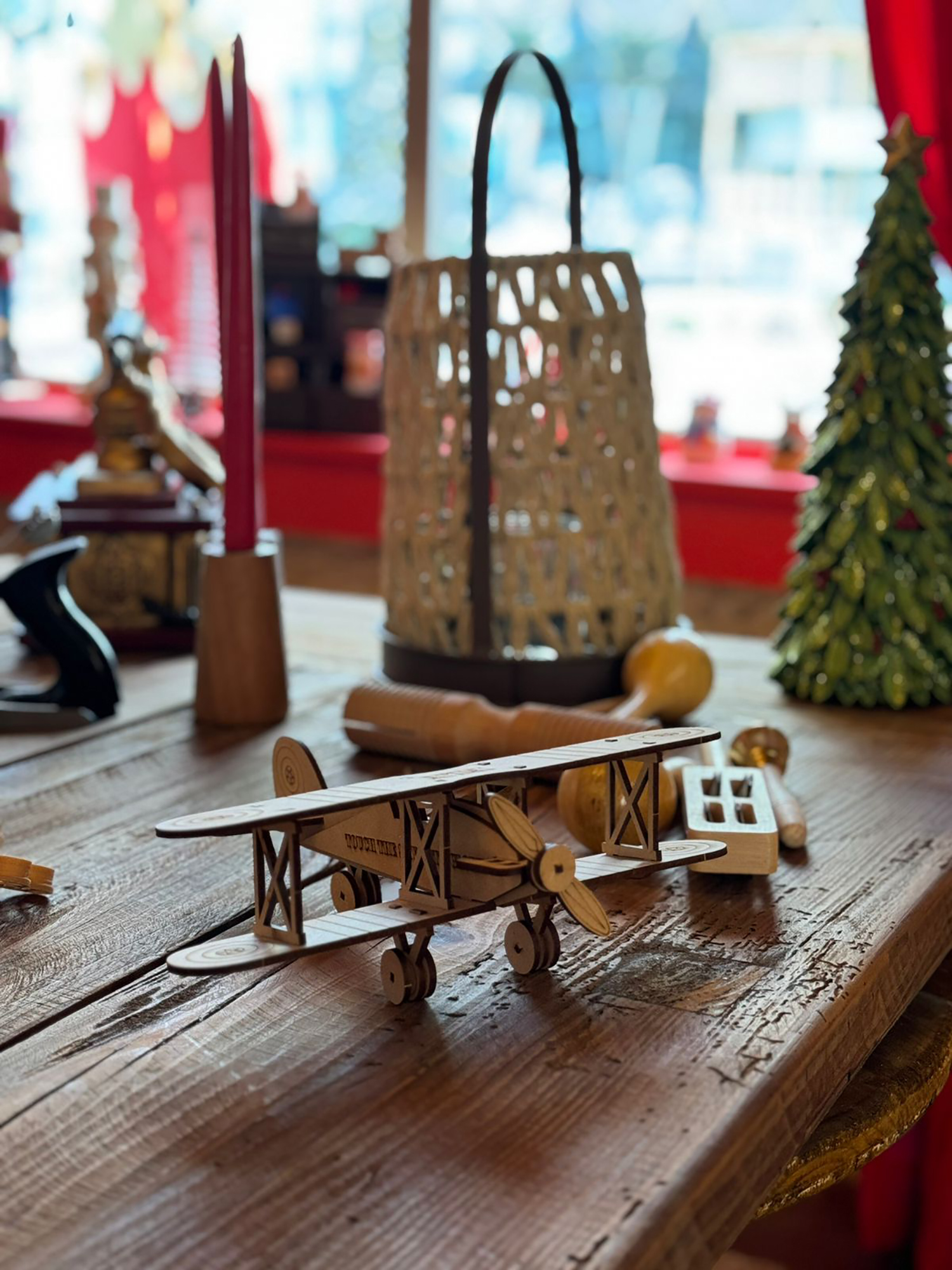 Custom scenic worktable and storage joinery forming the central festive workshop environment.