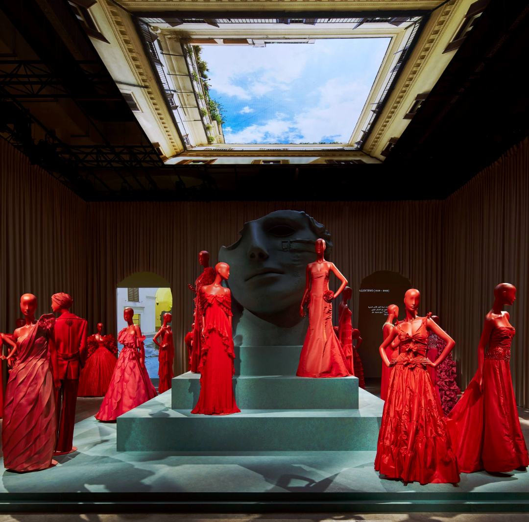 Minimal scenic fabric intervention defining a large venue with limited constructed elements.
