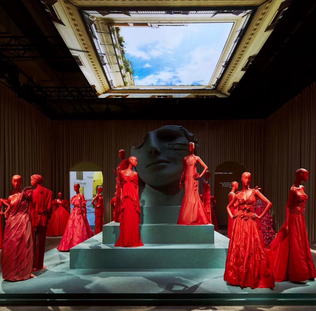 Minimal scenic fabric intervention defining a large venue with limited constructed elements.
