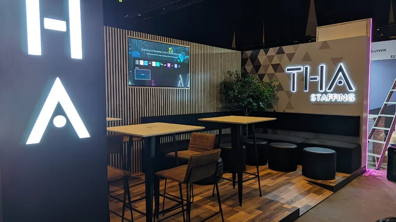 Evolution Scenic triangular wall with vinyl graphics, screen integration and illuminated THA signage.