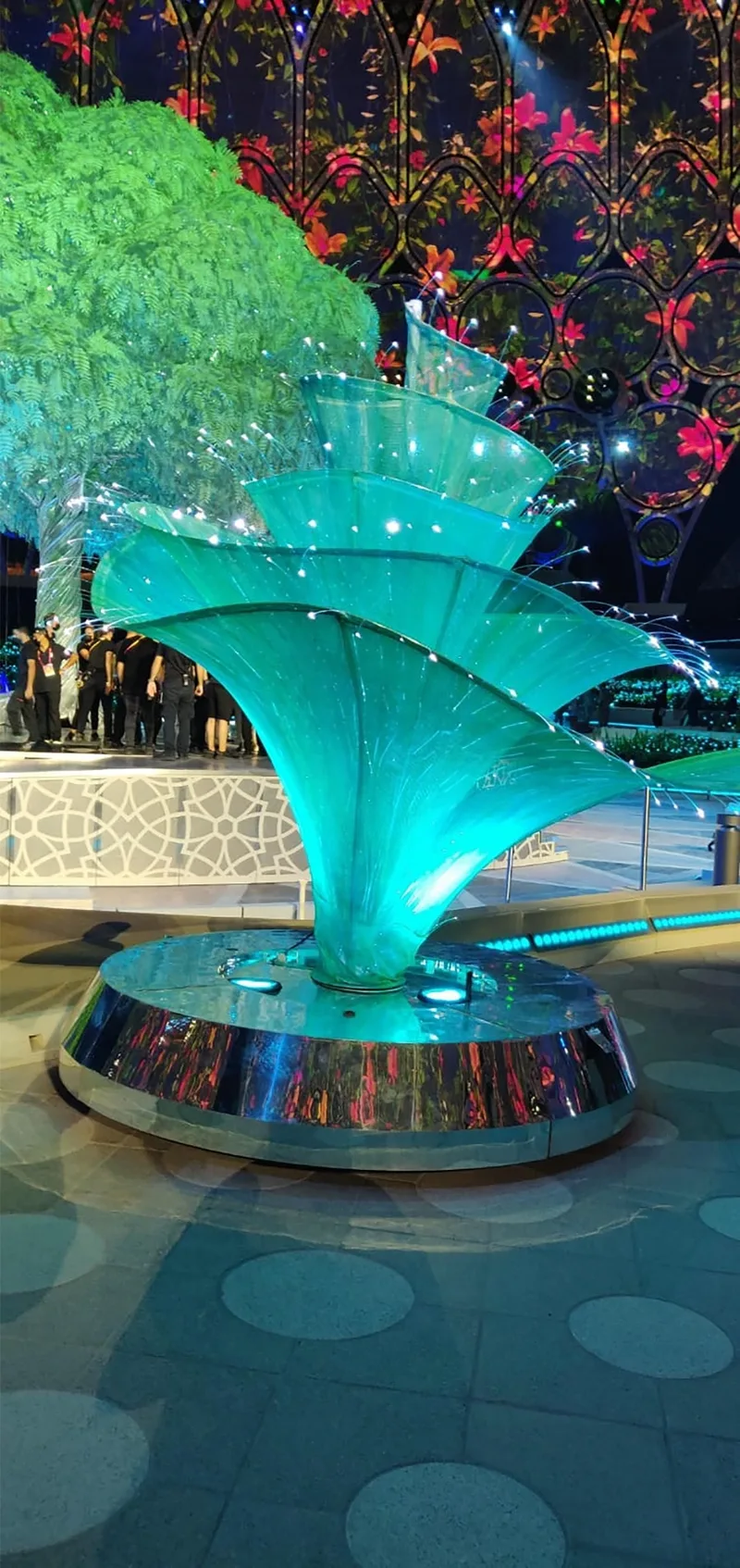 Colour-changing fibre-optic cables illuminating the edges of the fabricated flower petals.