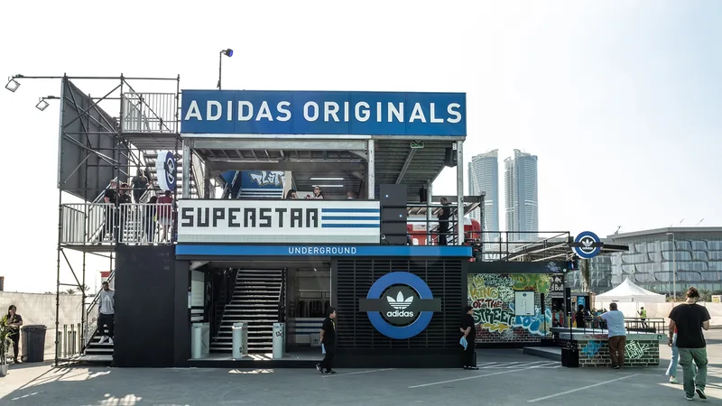 Multi-level Adidas retail environment incorporating branded scenic panels and architectural features.