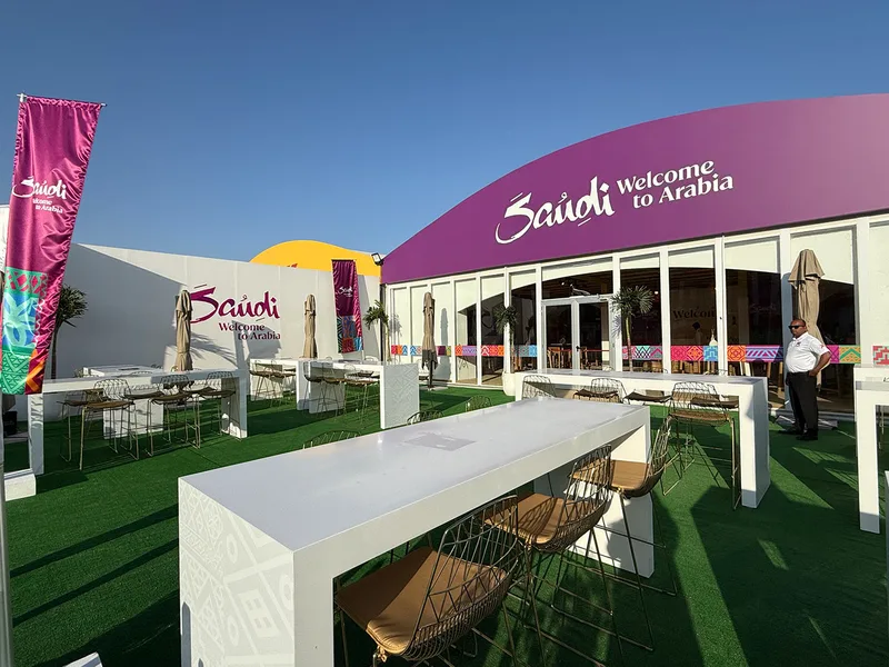 Evolution Scenic outdoor seating area with custom high tables, AstroTurf flooring and branded entrance.