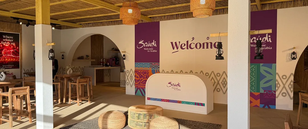 Evolution Scenic Visit Saudi tent with branded entrance, barasti ceiling and custom hospitality fit-out.