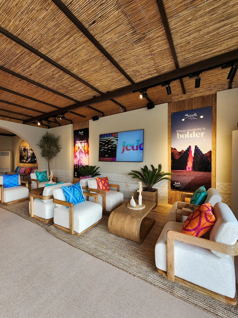 Wall-mounted television screen integrated into the textured scenic interior.