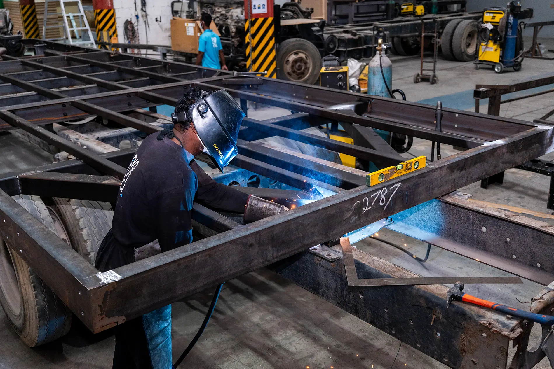 Fabricated mounting interface connecting scenic subframe to vehicle chassis
