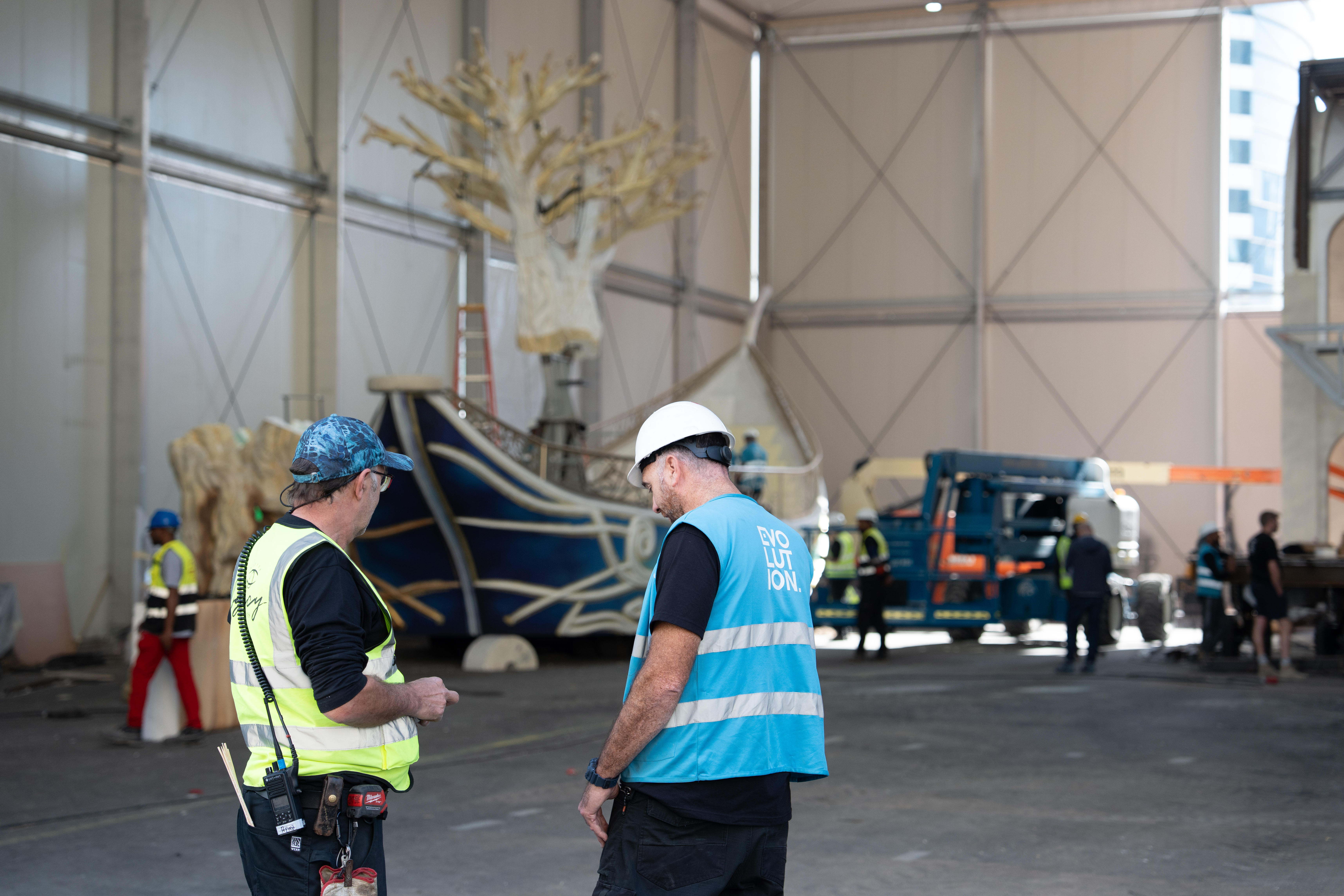 Long scenic float completing a turning-clearance test for projecting structural elements.