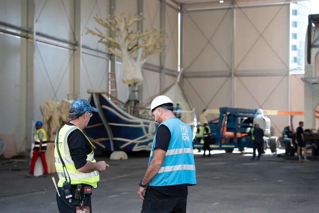 Long scenic float completing a turning-clearance test for projecting structural elements.